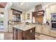 Modern kitchen with granite countertops, ample cabinetry, and a large island at 7435 Gathering Ct, Reunion, FL 34747