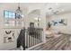 Upstairs landing overlooking the Gathering room, featuring a stylish staircase and artwork at 7435 Gathering Ct, Reunion, FL 34747