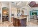 Open concept kitchen with an island, granite countertops and stainless steel appliances at 7435 Gathering Ct, Reunion, FL 34747
