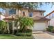 Mediterranean style home with tile roof and landscaping at 7435 Gathering Ct, Reunion, FL 34747