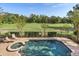 Resort-style pool and spa overlooking a golf course at 7435 Gathering Ct, Reunion, FL 34747