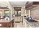 Modern kitchen with granite countertops, ample cabinetry, and a large island at 7435 Gathering Ct, Reunion, FL 34747