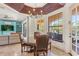 Breakfast nook with a round glass table and four chairs, offering natural light and pool views at 7435 Gathering Ct, Reunion, FL 34747