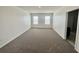 Large bedroom with carpet and two windows at 1823 Veterans Dr, Kissimmee, FL 34744
