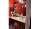 Bathroom with single sink vanity and red walls at 2440 Summerfield Way, Kissimmee, FL 34741