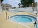 Community pool and spa with lounge chairs at 2440 Summerfield Way, Kissimmee, FL 34741