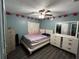 Cozy bedroom featuring a double bed, dresser, and decorative pillows at 2440 Summerfield Way, Kissimmee, FL 34741