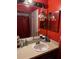 Bathroom with single sink vanity and red walls at 2440 Summerfield Way, Kissimmee, FL 34741