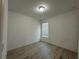 Simple bedroom with wood-look floors and window at 3960 Steer Beach Pl, Kissimmee, FL 34746