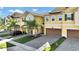 Front view of townhouses with garages and landscaping at 9824 Red Eagle Dr, Orlando, FL 32825