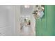 Interior view of entryway with green door and view to living area at 9824 Red Eagle Dr, Orlando, FL 32825