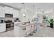 Modern kitchen with white cabinets, gray island, and stainless steel appliances at 9824 Red Eagle Dr, Orlando, FL 32825