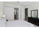 Bedroom with a queen bed, double doors to a bathroom, and a dresser at 434 Captiva Dr, Davenport, FL 33896