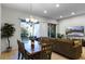 Open dining area with a wooden table and access to a patio at 434 Captiva Dr, Davenport, FL 33896