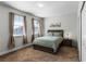 Bright bedroom with a queen bed, two windows, and wood nightstands at 434 Captiva Dr, Davenport, FL 33896