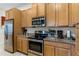 Kitchen with stainless steel appliances and wood cabinets at 434 Captiva Dr, Davenport, FL 33896