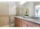 Bathroom with double vanity, granite countertop, and a shower at 434 Captiva Dr, Davenport, FL 33896