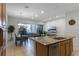 Open kitchen with granite countertops, stainless steel appliances, and light wood cabinets at 434 Captiva Dr, Davenport, FL 33896