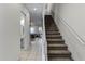 Modern staircase with neutral carpeting and a clean white railing at 434 Captiva Dr, Davenport, FL 33896