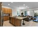Open concept kitchen with island, granite countertops, and stainless steel appliances at 434 Captiva Dr, Davenport, FL 33896