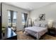 Bright bedroom with a queen bed, large windows, and a dresser at 434 Captiva Dr, Davenport, FL 33896