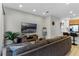 Comfortable living room featuring a sectional sofa and large TV at 434 Captiva Dr, Davenport, FL 33896
