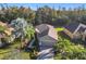 Single-story house with gray exterior, paver driveway and walkway, surrounded by palm trees at 100 Vizcaya Ct, Kissimmee, FL 34759