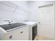 Bright laundry room, complete with washer, dryer, and ample shelving at 100 Vizcaya Ct, Kissimmee, FL 34759