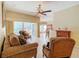 Living room with tiled floors, fireplace, and view of kitchen at 100 Vizcaya Ct, Kissimmee, FL 34759