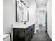 Modern bathroom with dark vanity, white countertop, and a large mirror at 224 Valencia Ridge Dr # 22, Auburndale, FL 33823