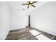 Bedroom with wood-look floors, ceiling fan, and access to another room at 224 Valencia Ridge Dr # 22, Auburndale, FL 33823