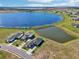 Aerial view of a house near a lake in a new development at 224 Valencia Ridge Dr, Auburndale, FL 33823