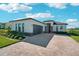 Single-story home with modern design, paver driveway, and landscaping at 224 Valencia Ridge Dr, Auburndale, FL 33823