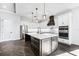 Bright kitchen with white cabinets, center island, and stainless steel appliances at 224 Valencia Ridge Dr, Auburndale, FL 33823