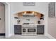 Gourmet kitchen with a brick accent wall, stainless steel appliances, and custom cabinetry at 2780 Vickie Ct, Kissimmee, FL 34744