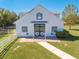 White barn with black accents and a paved pathway at 2780 Vickie Ct, Kissimmee, FL 34744