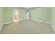 Spacious bedroom with light green walls, carpet, and access to a bathroom at 2780 Vickie Ct, Kissimmee, FL 34744