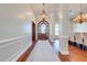 Elegant entryway with hardwood floors, chandelier, and arched doorway at 2780 Vickie Ct, Kissimmee, FL 34744