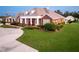 Brick home with landscaping, driveway, and partial view of pool at 2780 Vickie Ct, Kissimmee, FL 34744