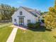 White barn with black accents, landscaping, and a walkway at 2780 Vickie Ct, Kissimmee, FL 34744