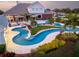 Freeform pool with a tanning ledge and surrounding landscaping at 2780 Vickie Ct, Kissimmee, FL 34744