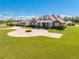 Brick home with circular driveway, landscaping, and detached guest house at 2780 Vickie Ct, Kissimmee, FL 34744