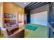 Golf simulator room with putting green, large screen, and view into dining room at 2780 Vickie Ct, Kissimmee, FL 34744