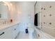 White bathroom with bathtub and shower, vanity with white cabinets, and tile flooring at 2780 Vickie Ct, Kissimmee, FL 34744