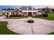 Brick home with circular driveway and lush landscaping at 2780 Vickie Ct, Kissimmee, FL 34744