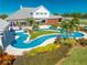 Unique freeform pool and spa with a bridge and lush landscaping at 2780 Vickie Ct, Kissimmee, FL 34744