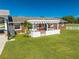 Backyard patio with pergola, grill, and white fence at 2780 Vickie Ct, Kissimmee, FL 34744