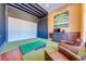 Golf simulator room with a large screen, putting green, and leather armchairs at 2780 Vickie Ct, Kissimmee, FL 34744