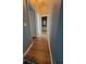 Hallway with wood-look flooring and access to bathroom at 153 Pompano Beach Dr, Kissimmee, FL 34746