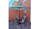 Patio with table and chairs under a striped umbrella at 153 Pompano Beach Dr, Kissimmee, FL 34746